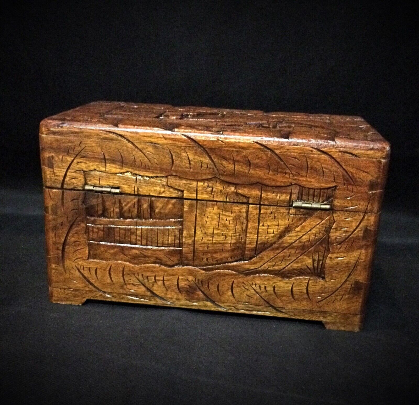 Elegant vintage wooden storage box with ornate carving
