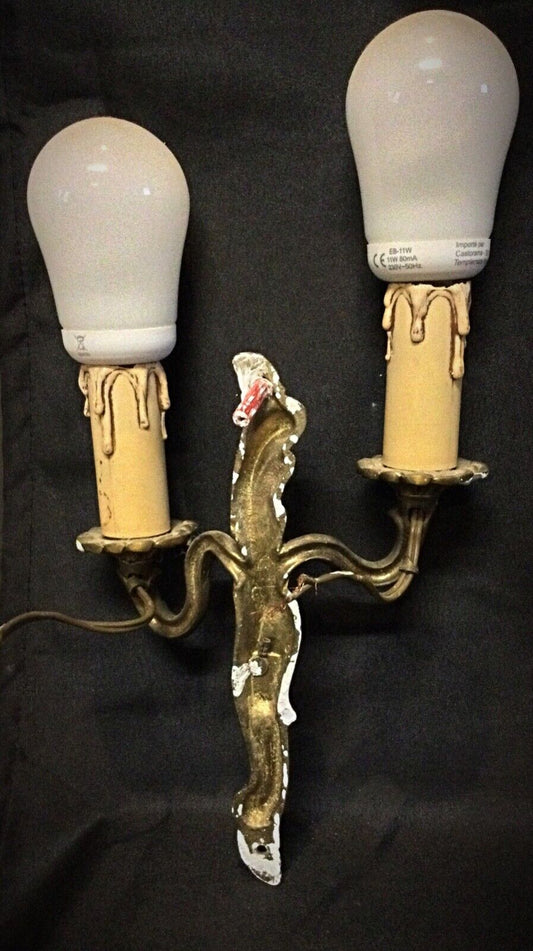 Close-up of intricate brass craftsmanship on vintage wall sconce
