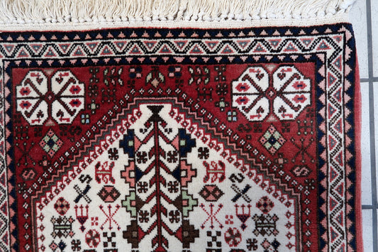 Close-up of the central diamond shape motif surrounded by floral and geometric patterns