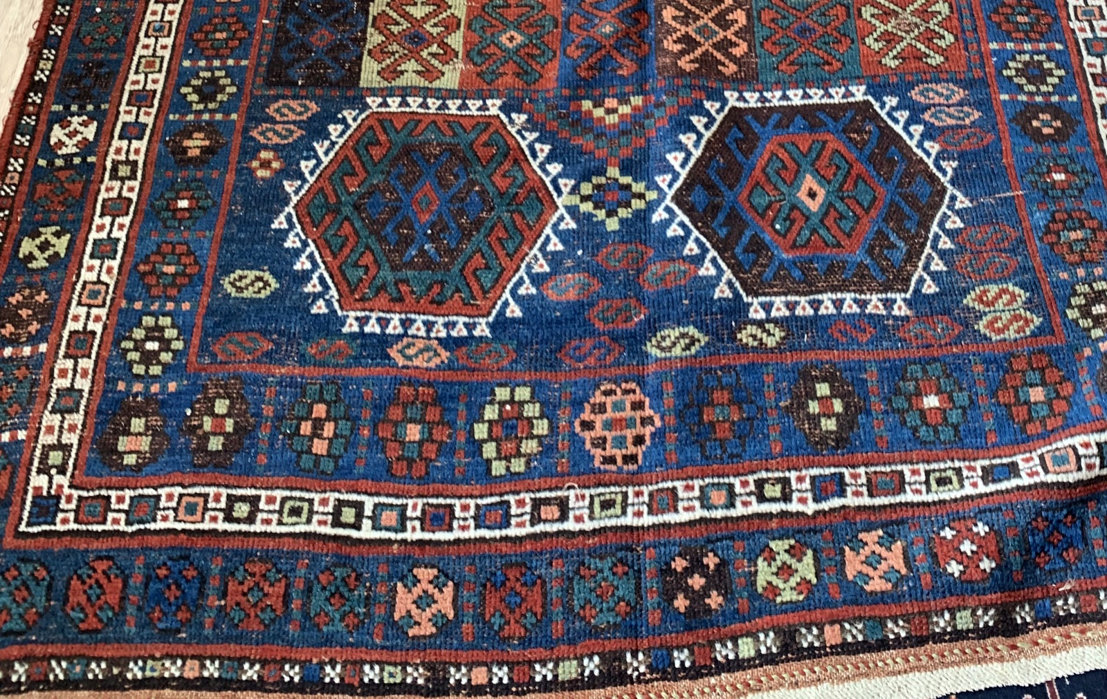 Hand-knotted wool texture on antique rug from 1880s

