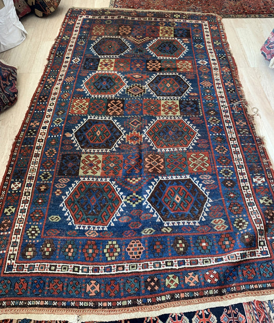 Close-up of tribal symbols in Persian Kurdish carpet

