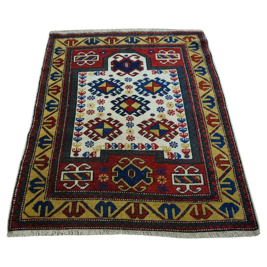Handmade Antique Caucasian Kazak Prayer Rug showcased in a cozy living room setting