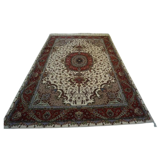 Handmade vintage Persian Tabriz rug displayed in an elegant living room setting