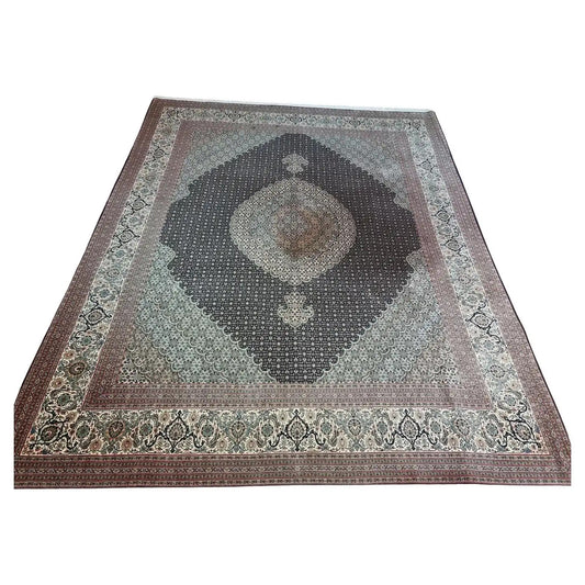 Handmade vintage Persian Tabriz 50 Raj rug featuring intricate patterns and muted tones from the 1980s