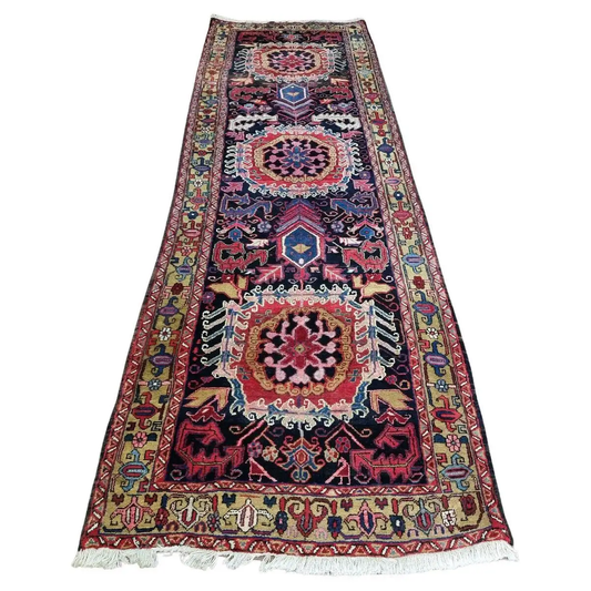 Handmade Antique Persian Heriz Runner Rug - 1920s - Vibrant geometric and floral patterns on a dark background.