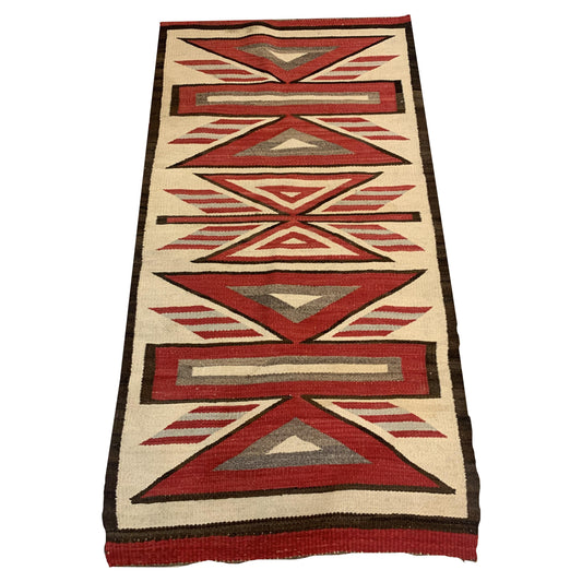 Handmade Antique Native American Navajo Rug Blanket displayed draped over a sofa