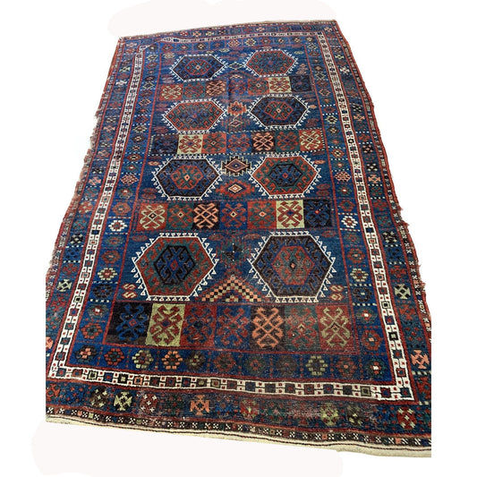 Antique Kurdish rug with deep blue field and geometric medallions

