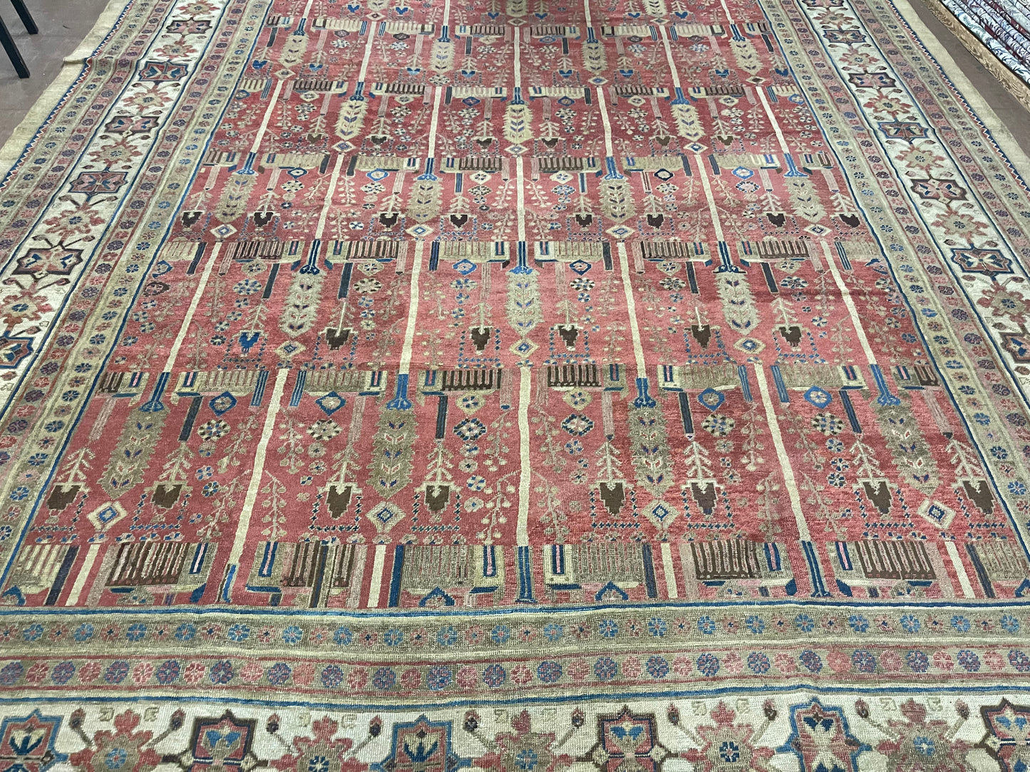 Detailed shot of the warm, rich red color dominating the palace-sized rug