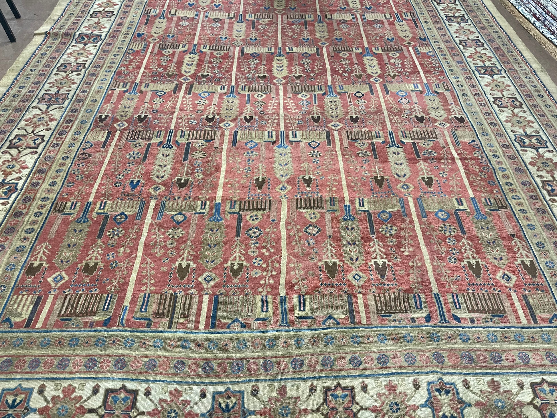 Detailed shot of the warm, rich red color dominating the palace-sized rug