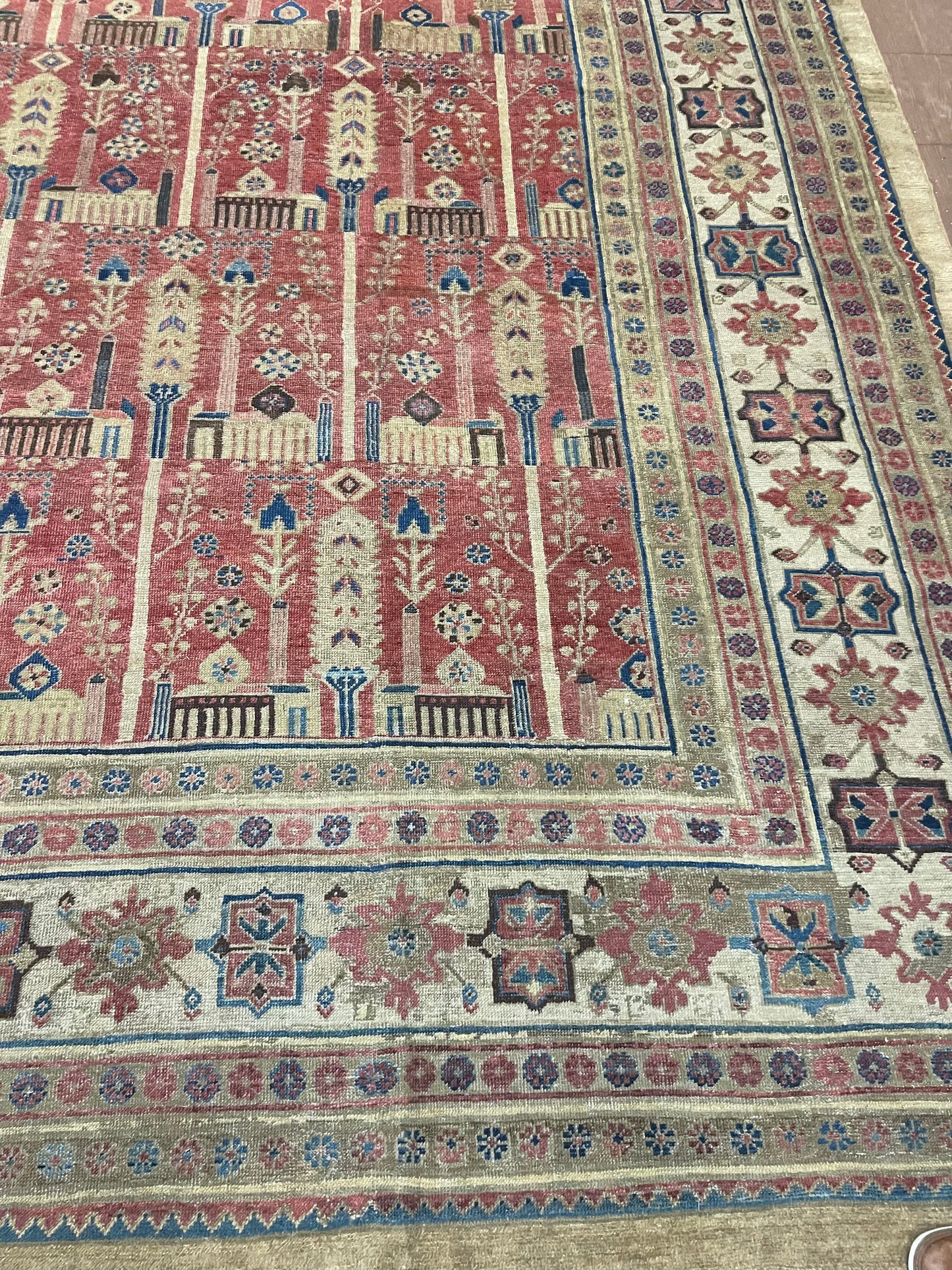Close-up of the hints of cream accentuating the palace-sized rug's design