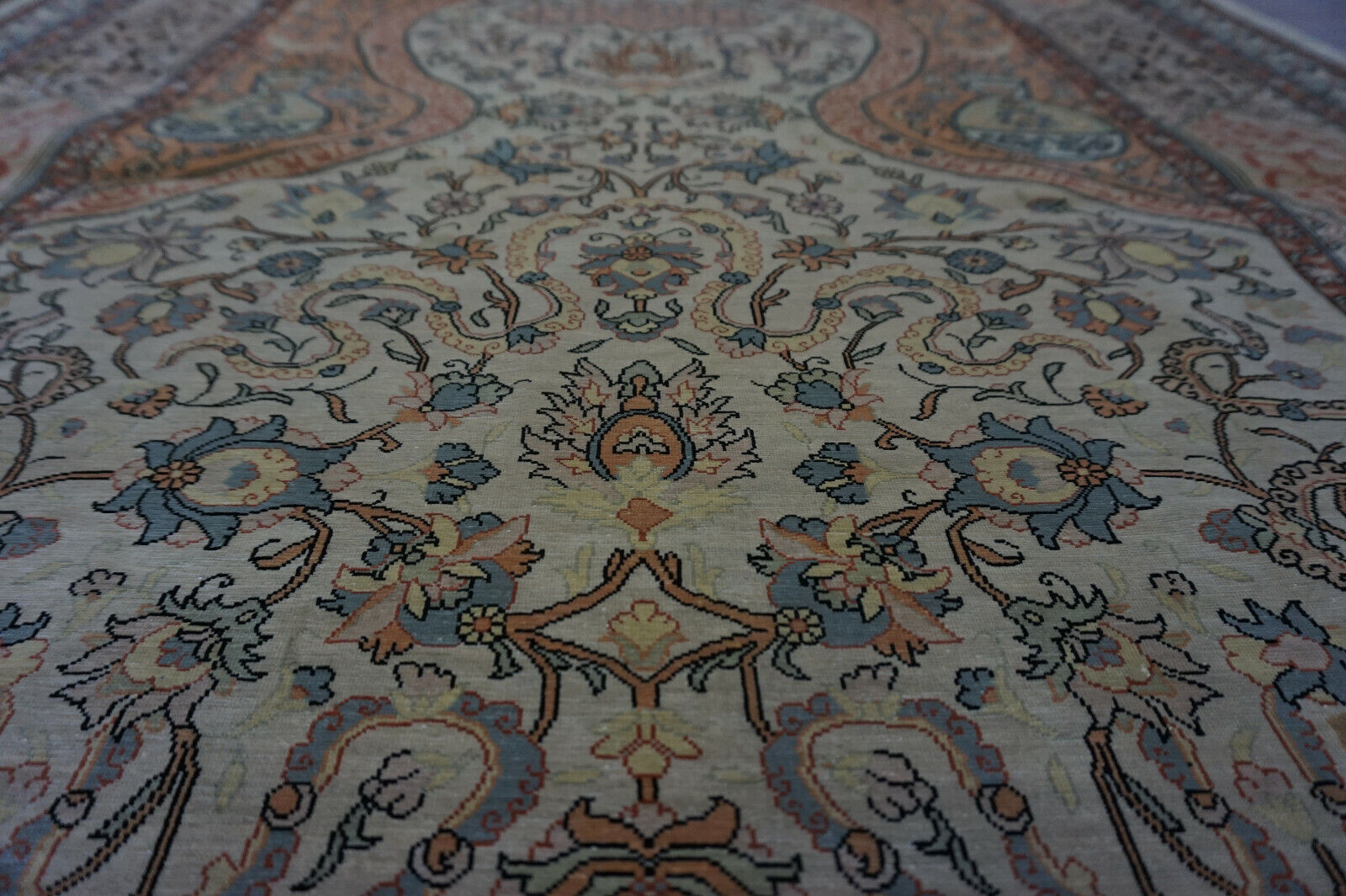 Close-up of the intricate patterns and symbols on the Handmade Vintage Turkish Hereke Silk Rug
