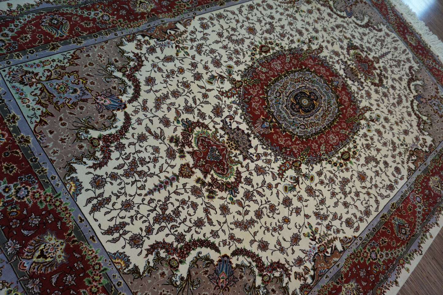 Side angle shot of the Persian Tabriz rug enhancing the elegance of a bedroom