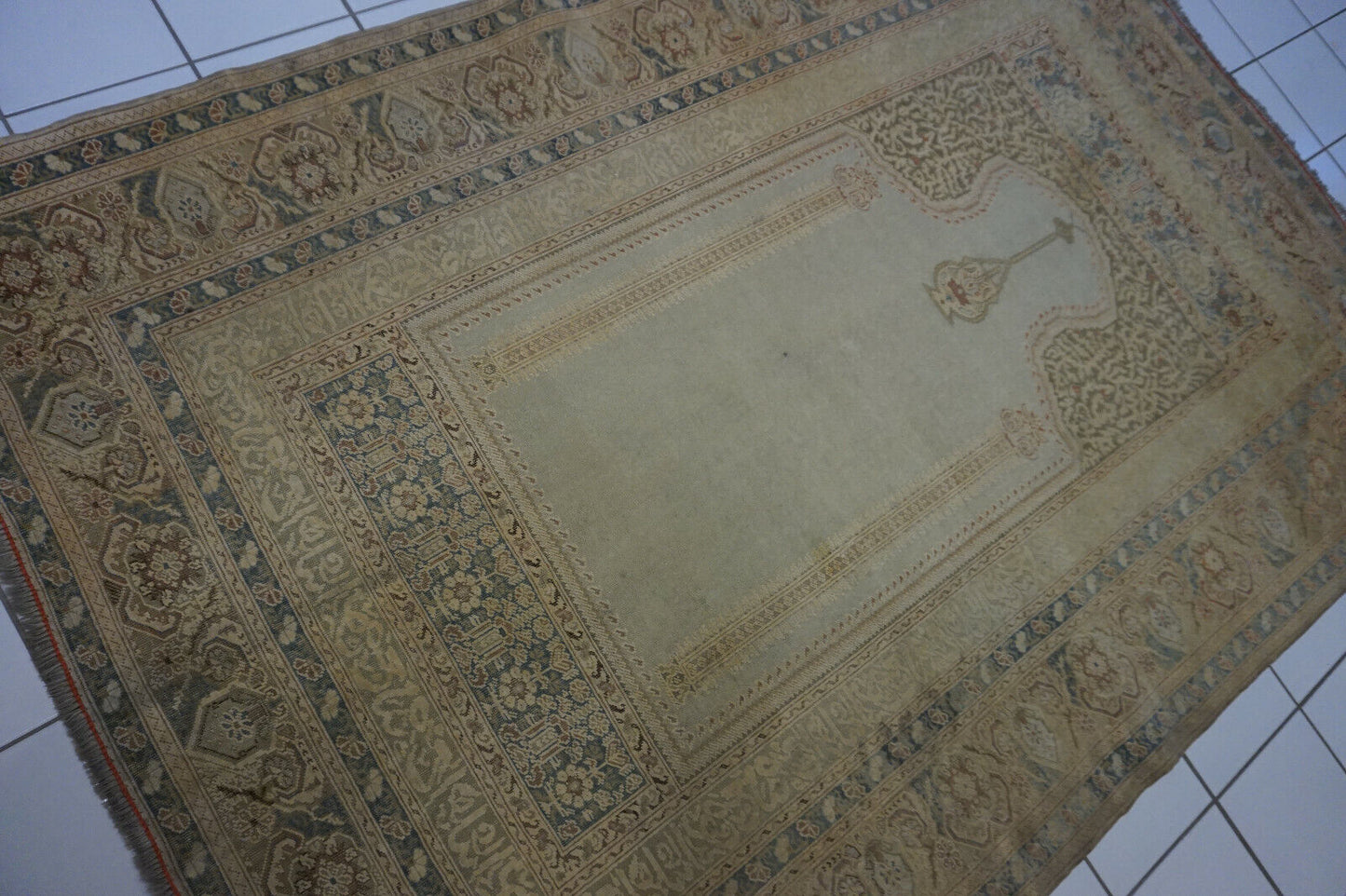 Side angle shot of the Turkish Transilvania prayer rug complementing classic furniture in a bedroom