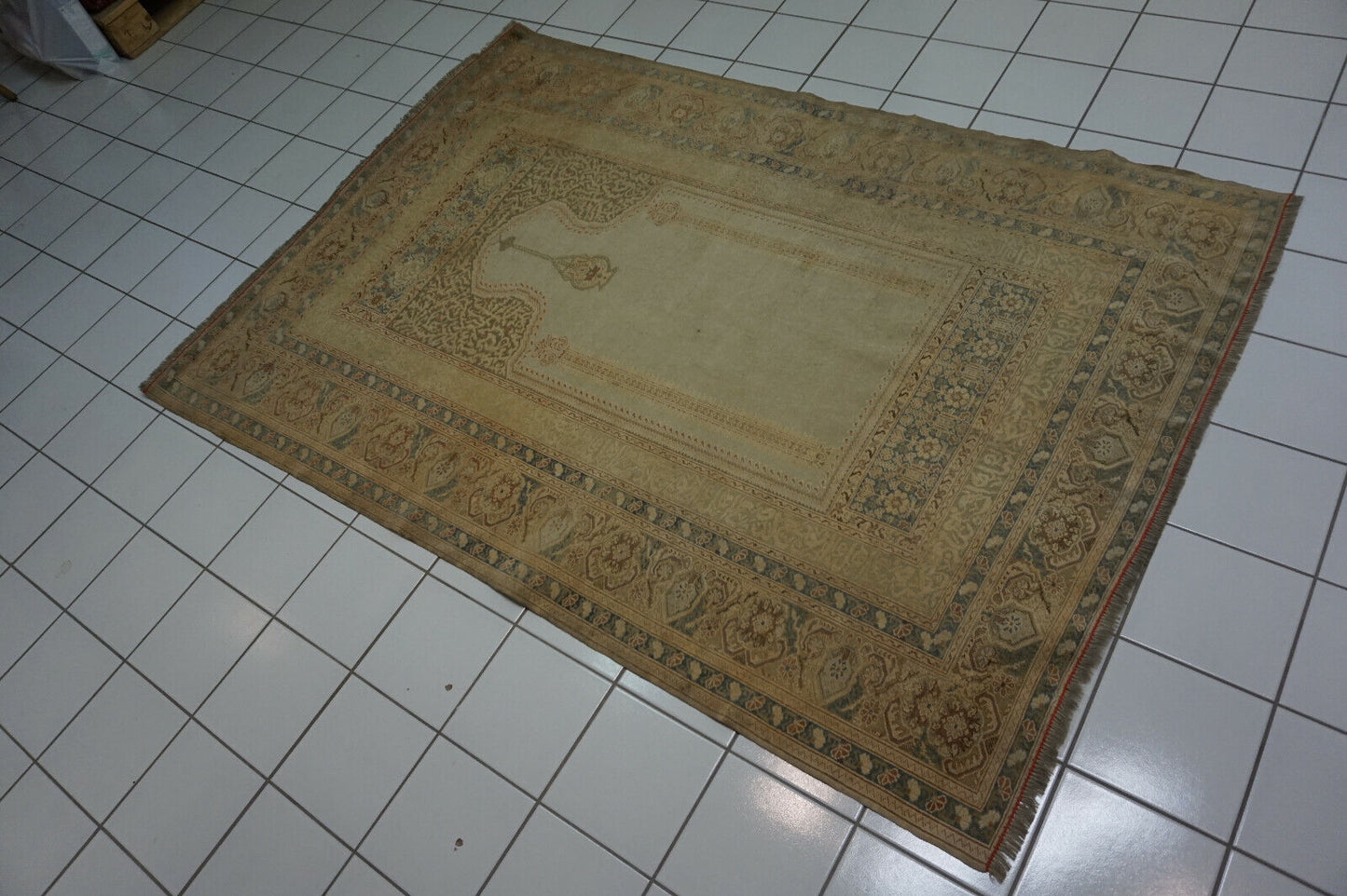 Detailed view of the low pile texture and vintage charm of the rug