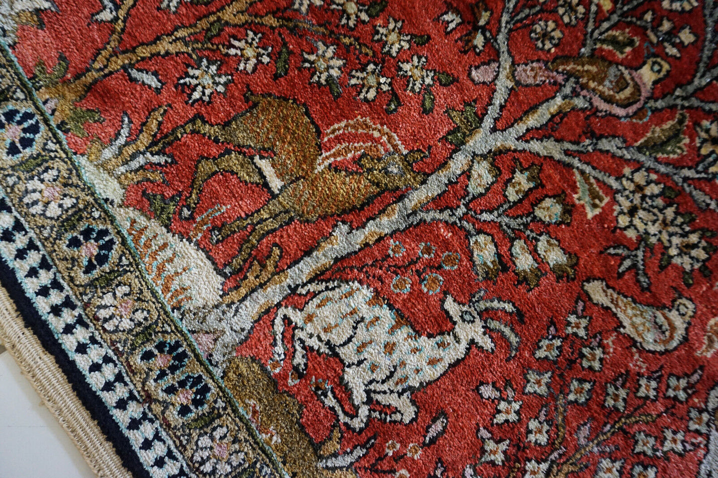 Detailed shot of the luminous sheen and vibrant colors of the Persian Qum silk rug