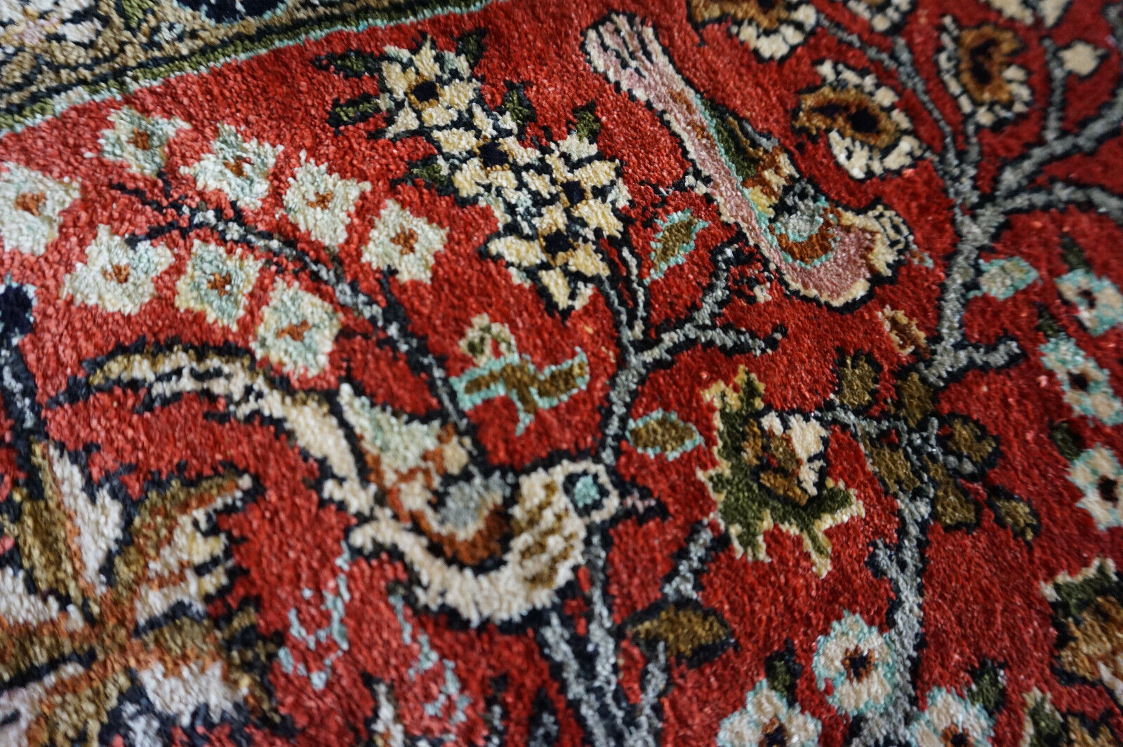 Overhead shot of the Persian Qum silk rug demonstrating its fine silk weave