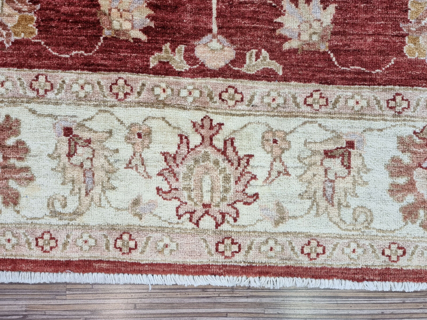 Close-up of geometric motifs on Handmade Vintage Afghan Zigler Rug - Detailed view highlighting the geometric motifs integrated into the rug's design.