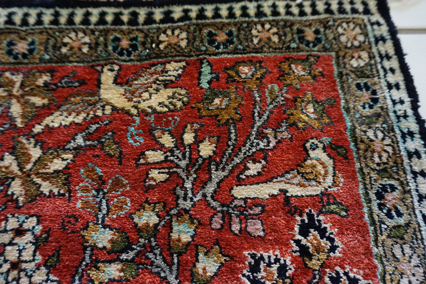 Side view of the Persian Qum silk rug highlighting its rectangular shape and size