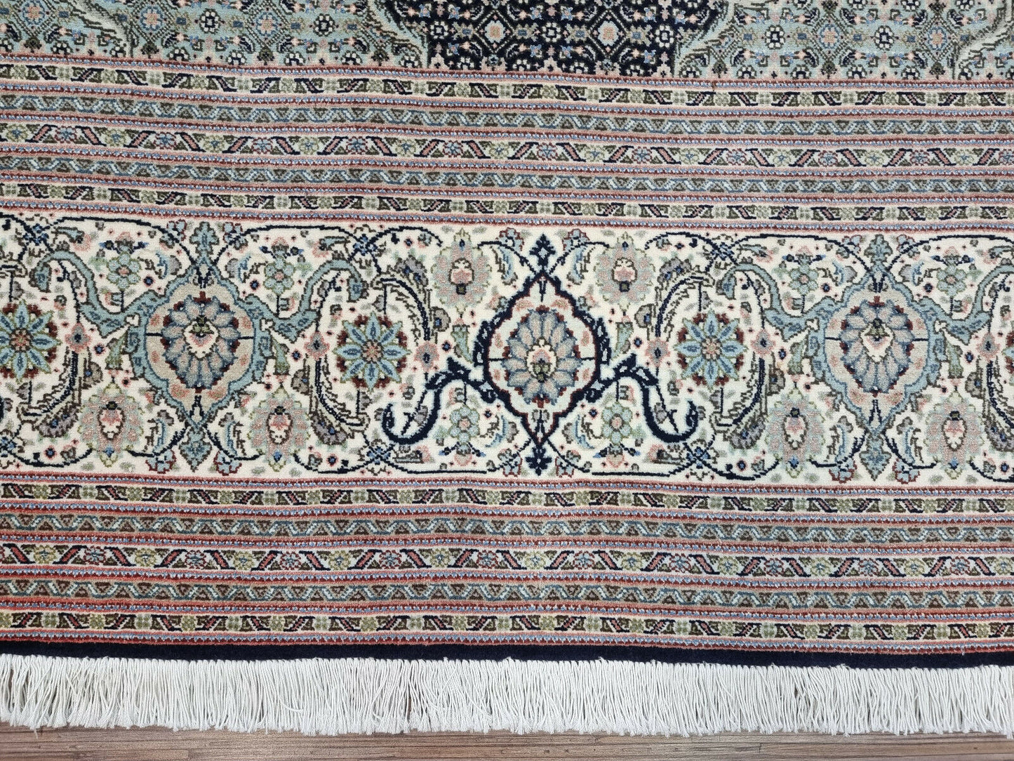 Close-up of the central medallion and detailed patterns on the Tabriz 50 Raj rug