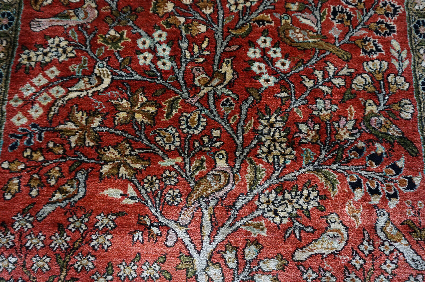 Close-up of the intricate "tree of life" motif on the Persian Qum silk rug