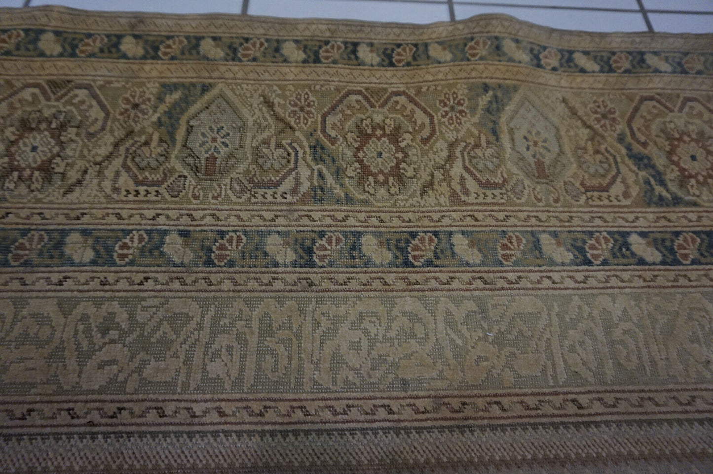 Close-up of the intricate motifs and low pile texture on the Turkish Transilvania prayer rug