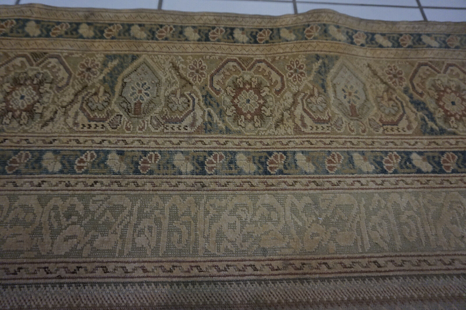 Close-up of the intricate motifs and low pile texture on the Turkish Transilvania prayer rug