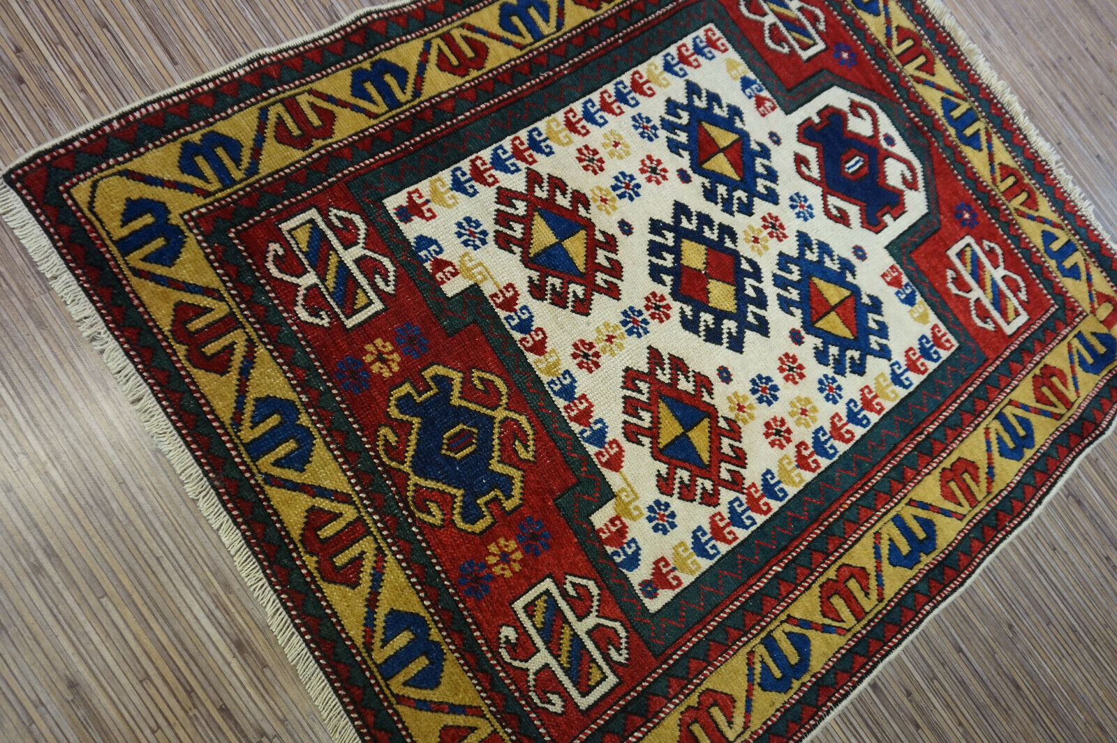 Close-up of the intricate stitching on the Handmade Antique Caucasian Kazak Prayer Rug