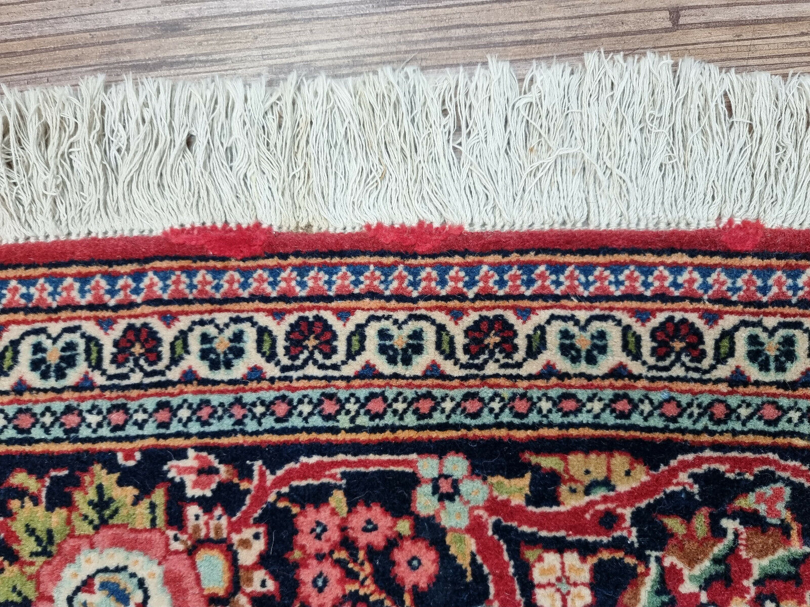Close-up of multicolored designs on Handmade Antique Persian Kashan Rug - Detailed view showcasing the vibrant multicolored designs adorning the rug.