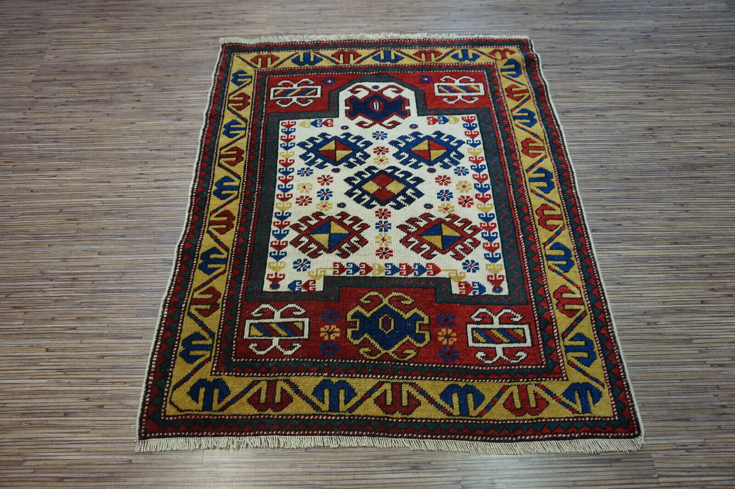 Side angle shot of the Handmade Antique Caucasian Kazak Prayer Rug showcasing size and scale