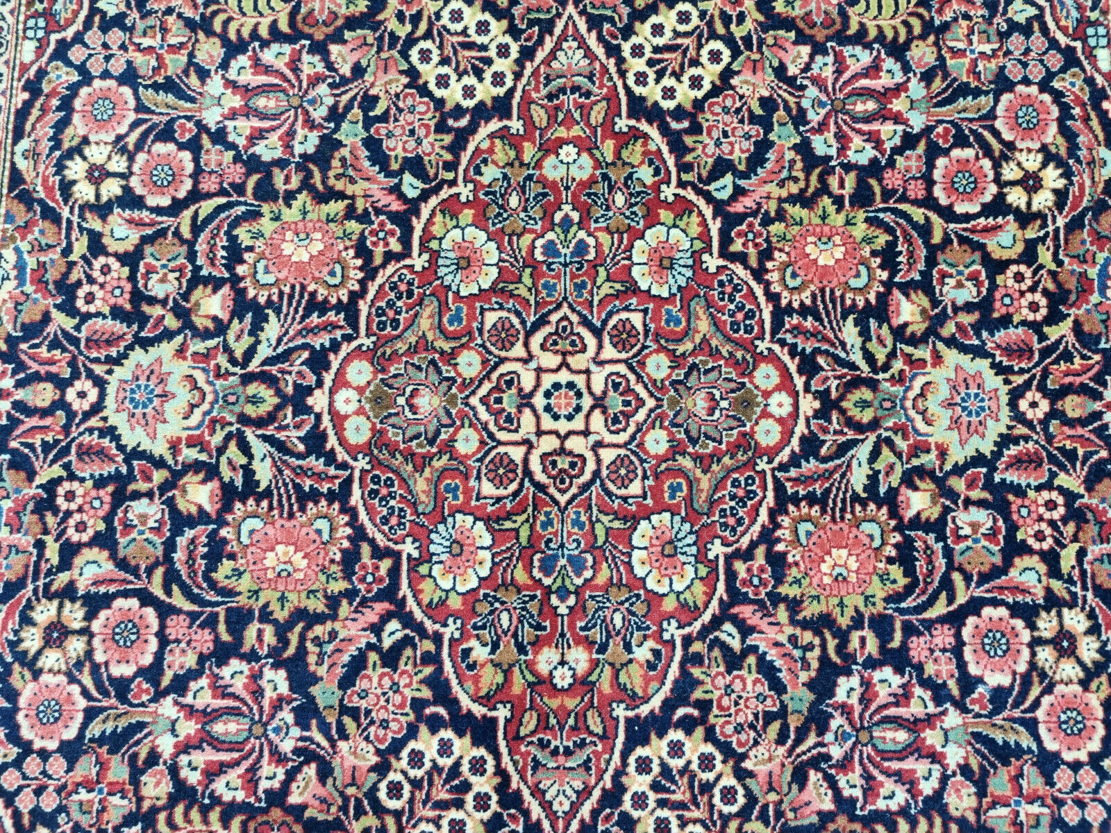 Close-up of dark base color on Handmade Antique Persian Kashan Rug - Detailed view emphasizing the dark base color of the rug's pattern.
