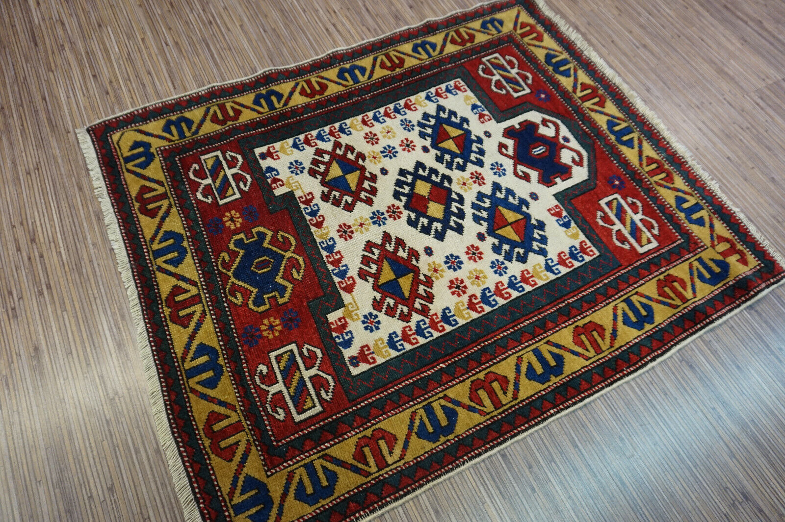 Angled shot of the Handmade Antique Caucasian Kazak Prayer Rug complementing interior decor