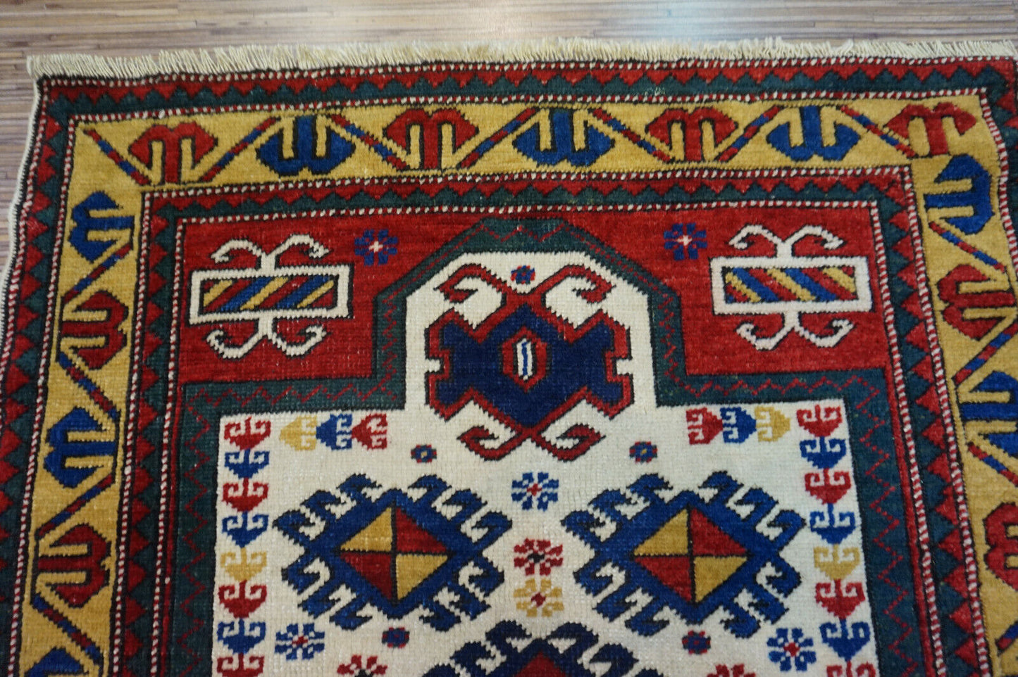 Front view of the Handmade Antique Caucasian Kazak Prayer Rug highlighting its traditional motifs