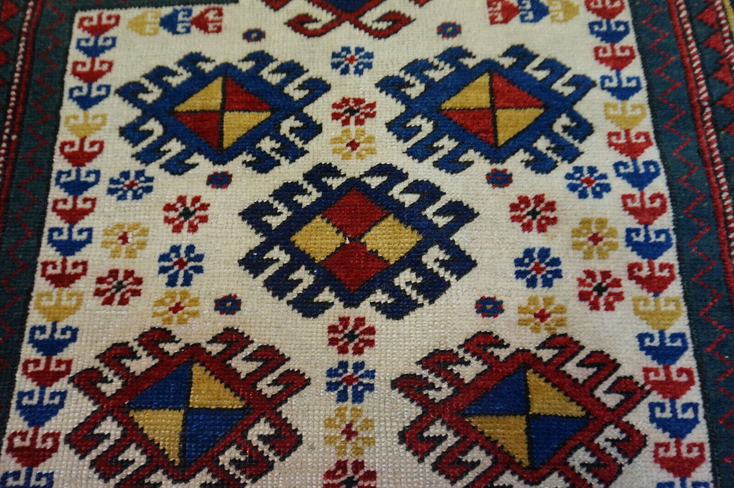 Close-up of the white background dominating the central field on the Handmade Antique Caucasian Kazak Prayer Rug