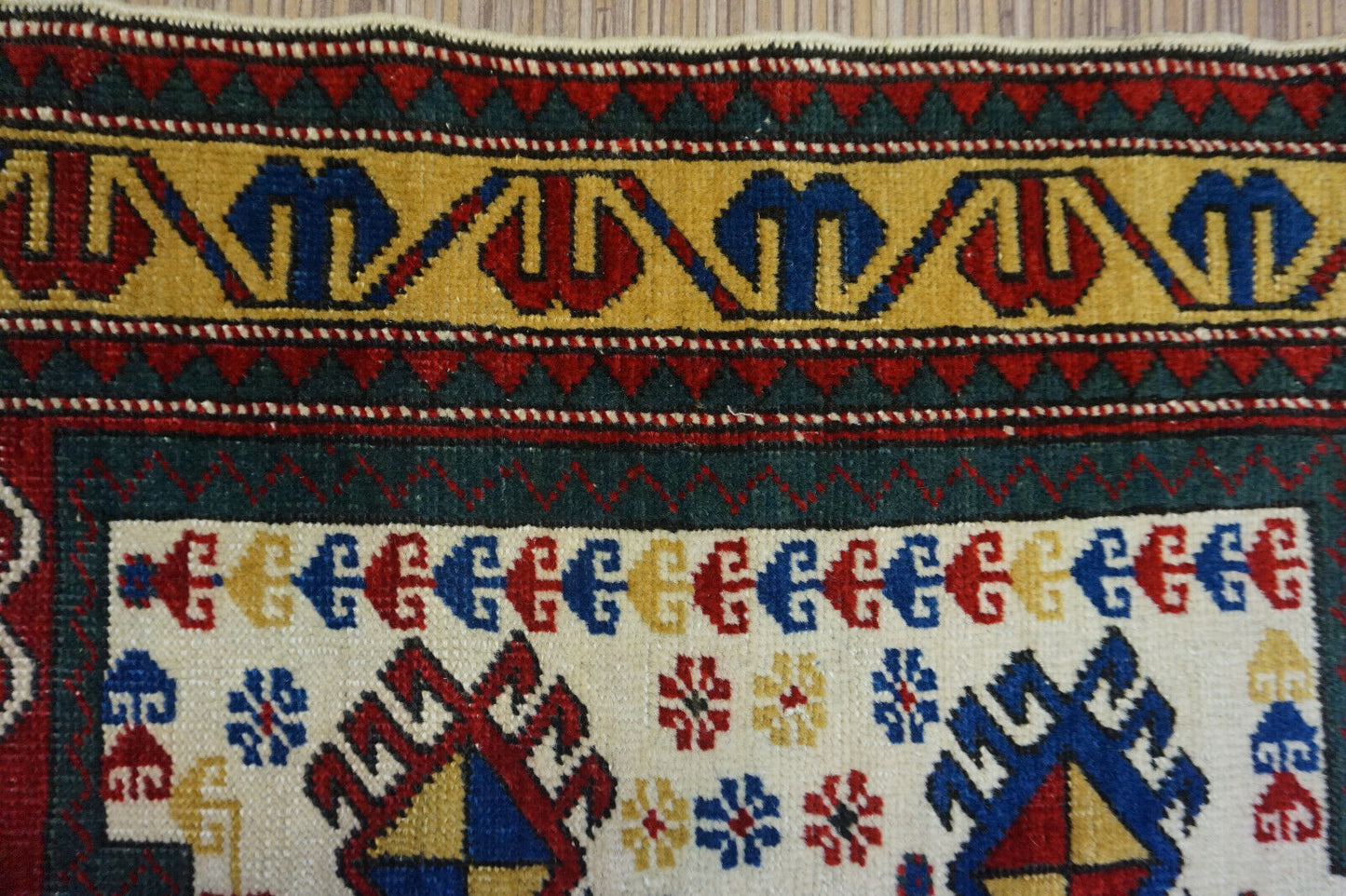 Side view of the Handmade Antique Caucasian Kazak Prayer Rug demonstrating its wool material