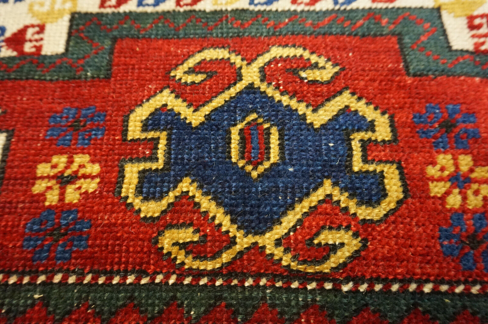 Close-up of the intricate geometric patterns on the Handmade Antique Caucasian Kazak Prayer Rug