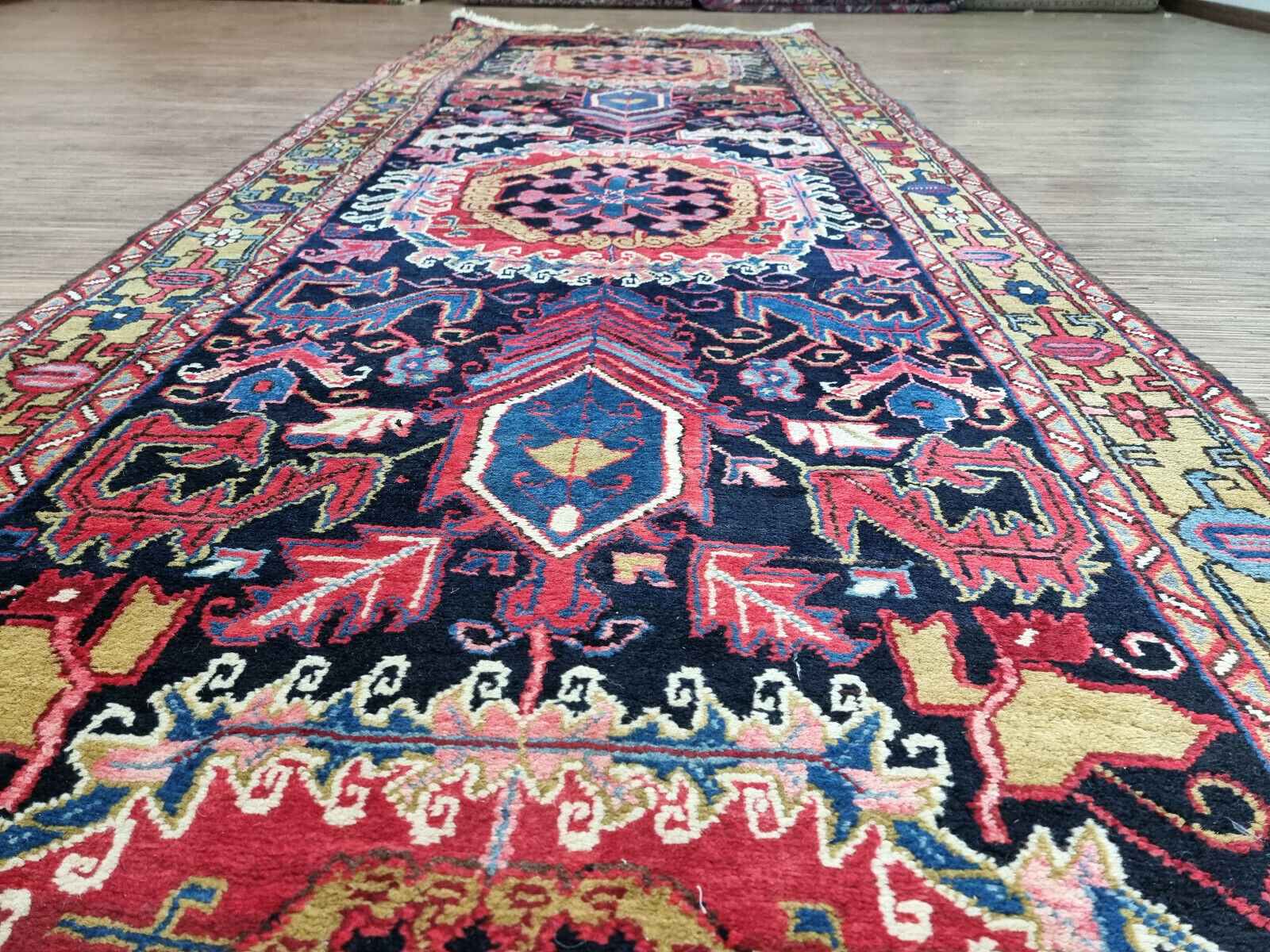 Close-up of intricate geometric patterns on Handmade Antique Persian Heriz Runner Rug - Detailed view showcasing the vibrant geometric patterns within the rug's design.