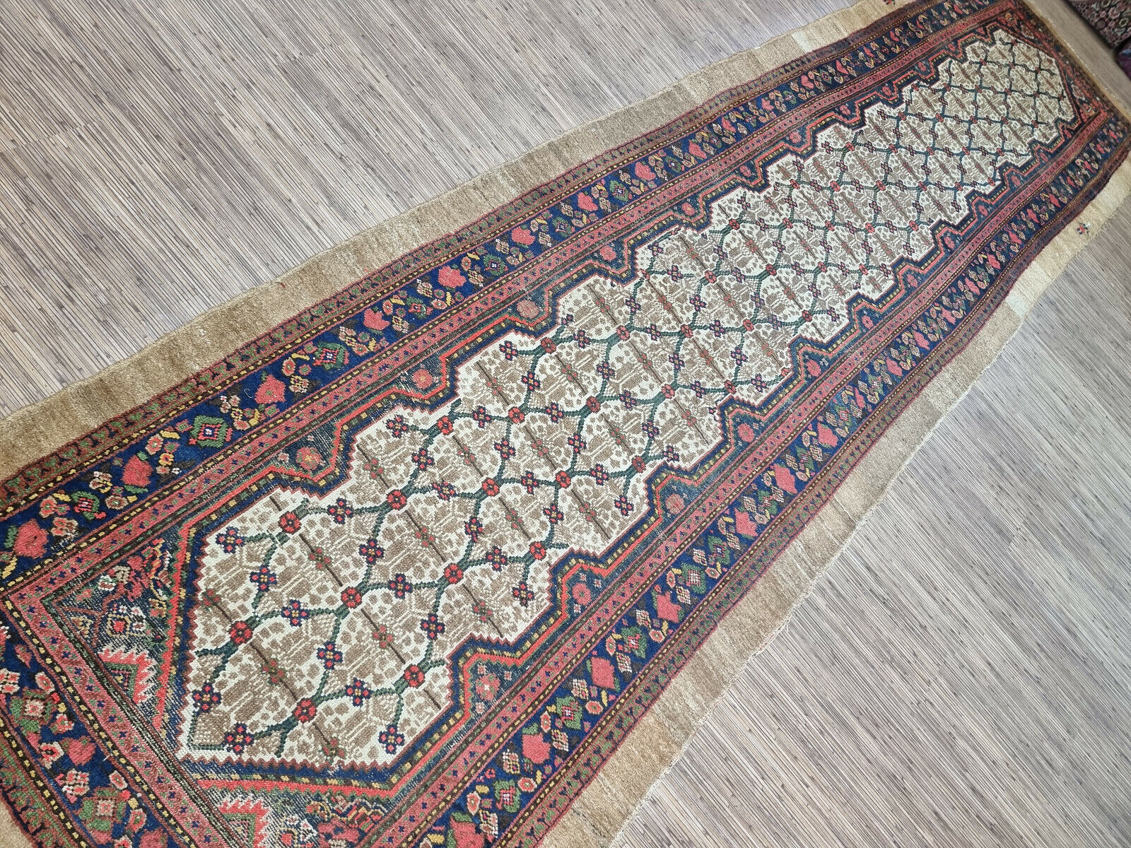 Close-up of detailed craftsmanship on Handmade Antique Persian Camel Hair Runner Rug - Detailed view showcasing the detailed craftsmanship involved in creating the rug's intricate patterns.