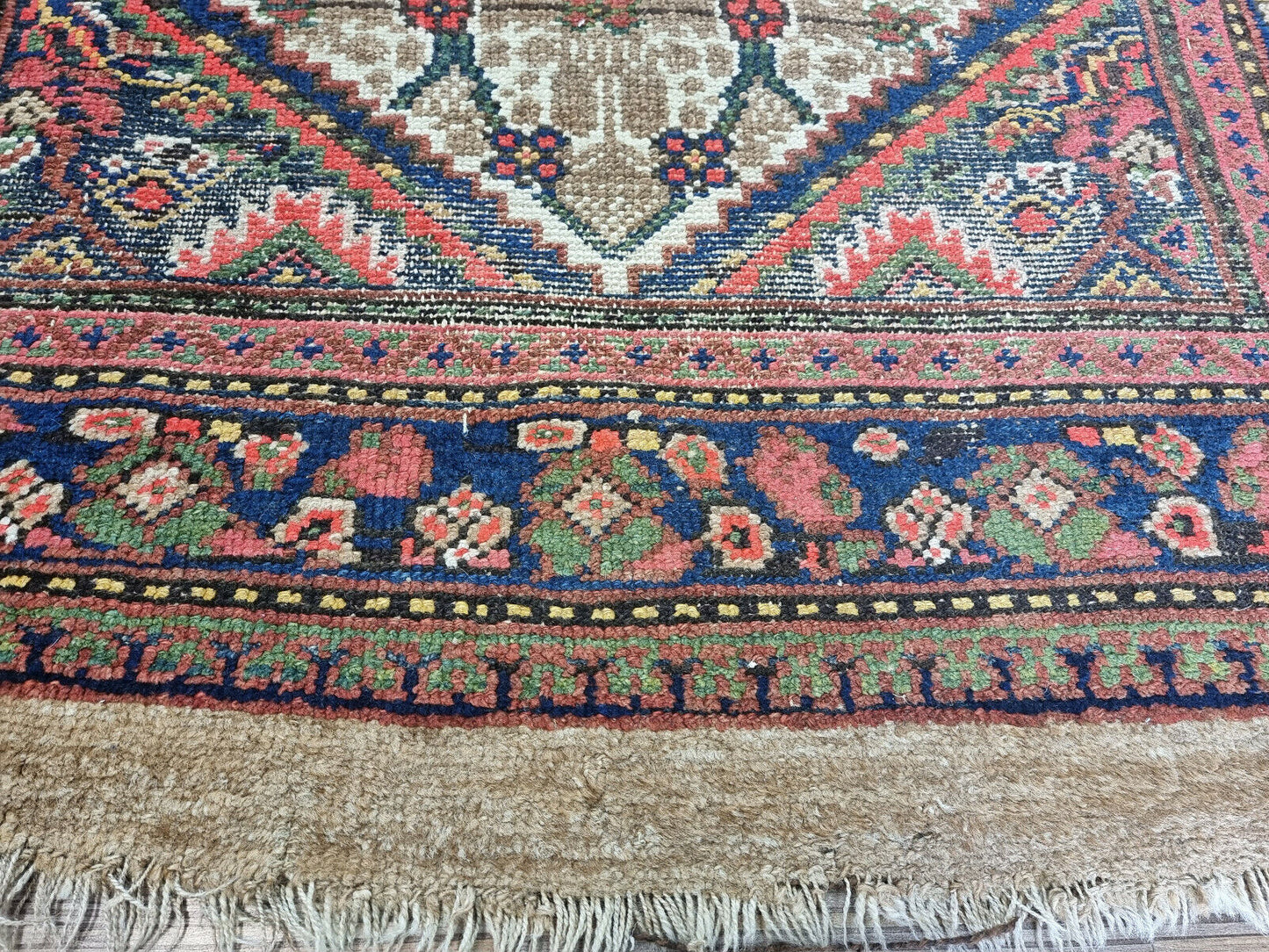 Close-up of deep red geometric shapes on Handmade Antique Persian Camel Hair Runner Rug - Detailed view highlighting the deep red geometric shapes within the rug's design.