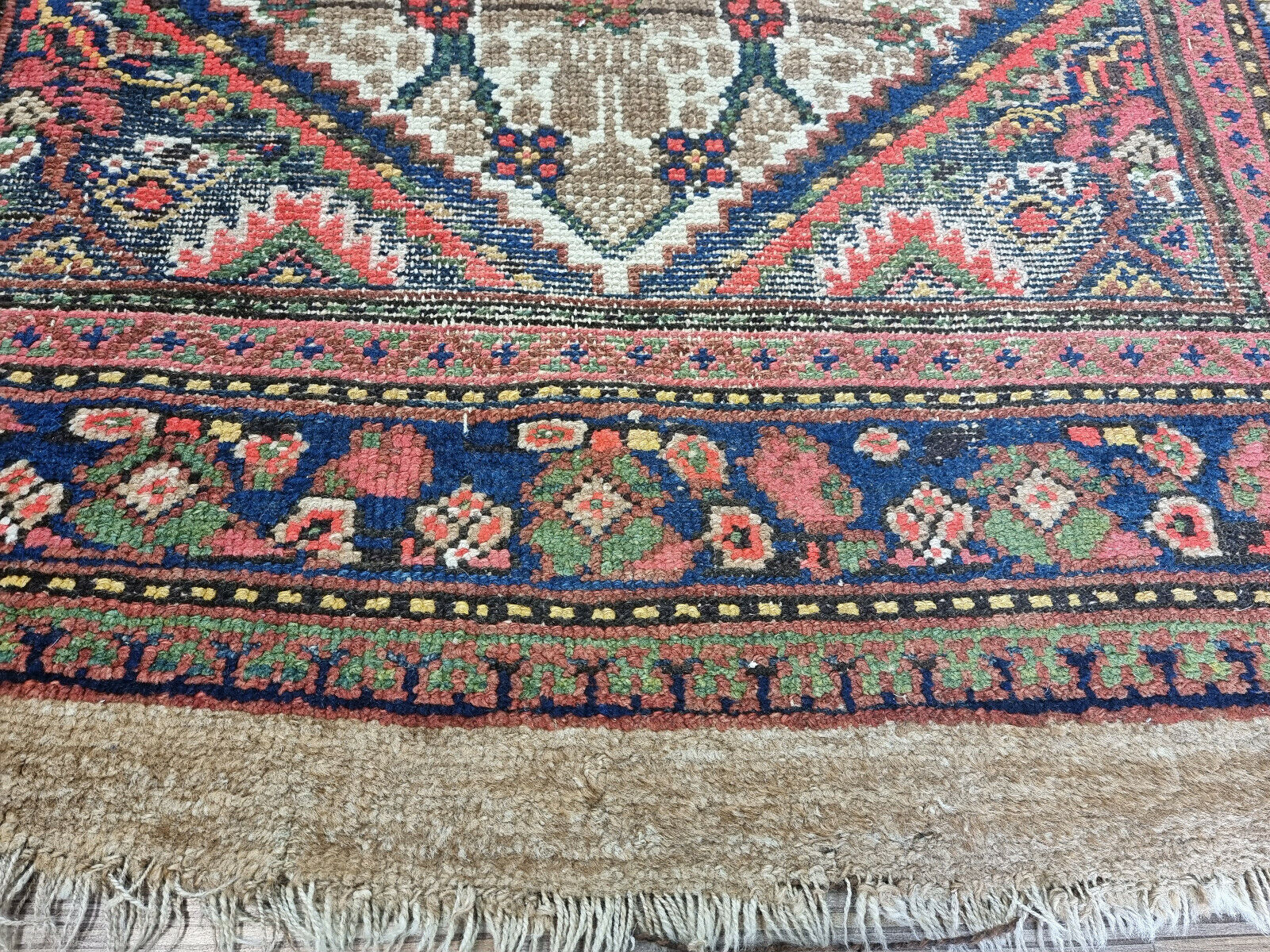 Close-up of deep red geometric shapes on Handmade Antique Persian Camel Hair Runner Rug - Detailed view highlighting the deep red geometric shapes within the rug's design.