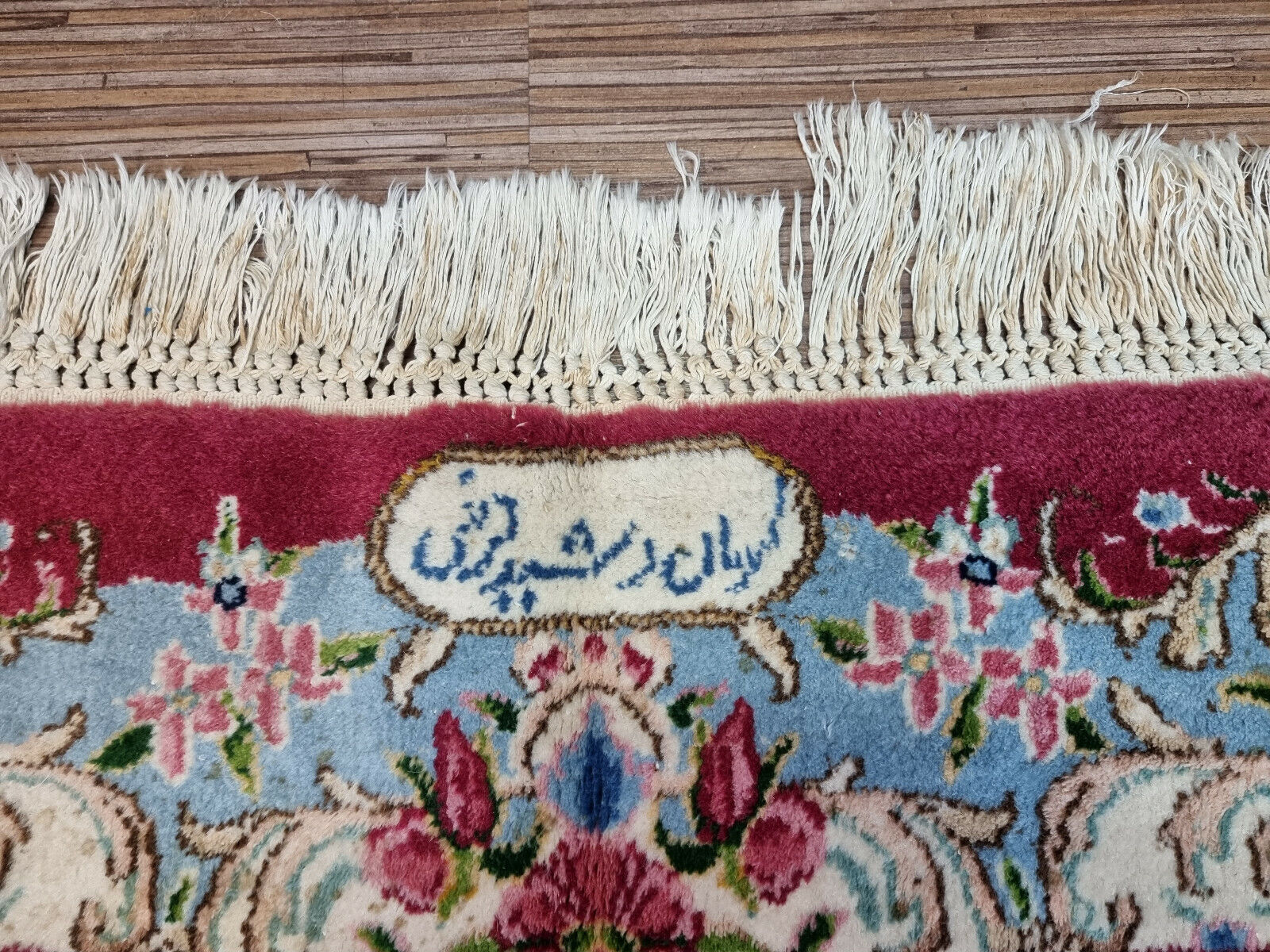 Close-up of blues, whites, and yellows against dark background on Handmade Vintage Persian Kerman Rug - Detailed view showcasing the color contrast of the border against the dark background.