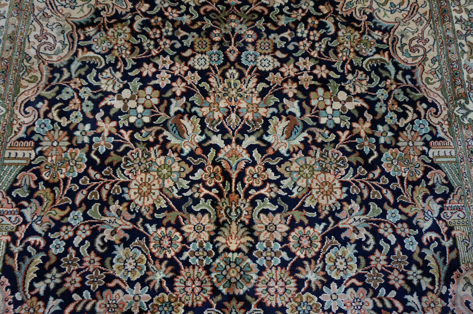 Detailed shot of the harmonious color palette on the Handmade Vintage Persian Kashmir Rug
