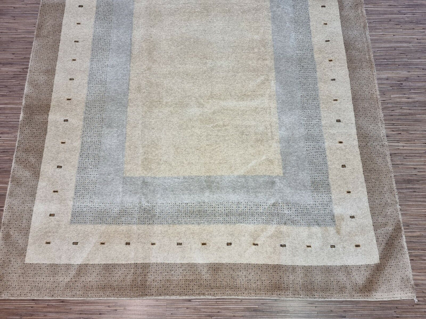 Detailed shot of the cream-colored elegance on the Handmade Vintage Persian Style Gabbeh Rug