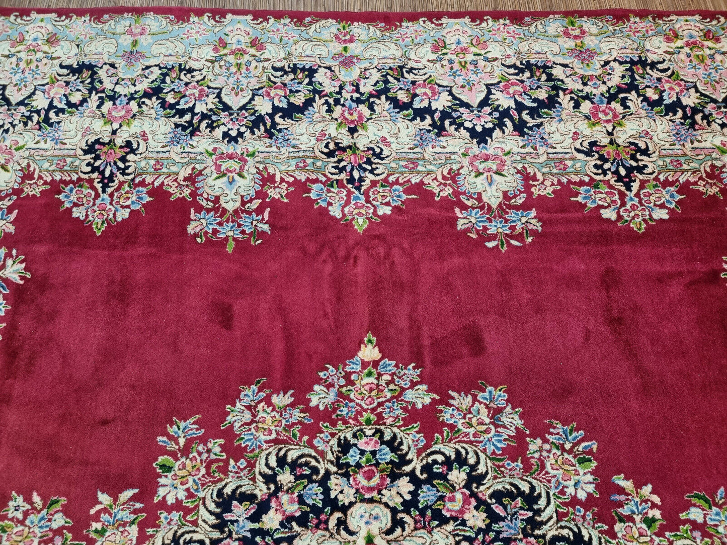 Close-up of floral and vine designs on Handmade Vintage Persian Kerman Rug - Detailed view showcasing the intricate floral and vine motifs woven into the rug.