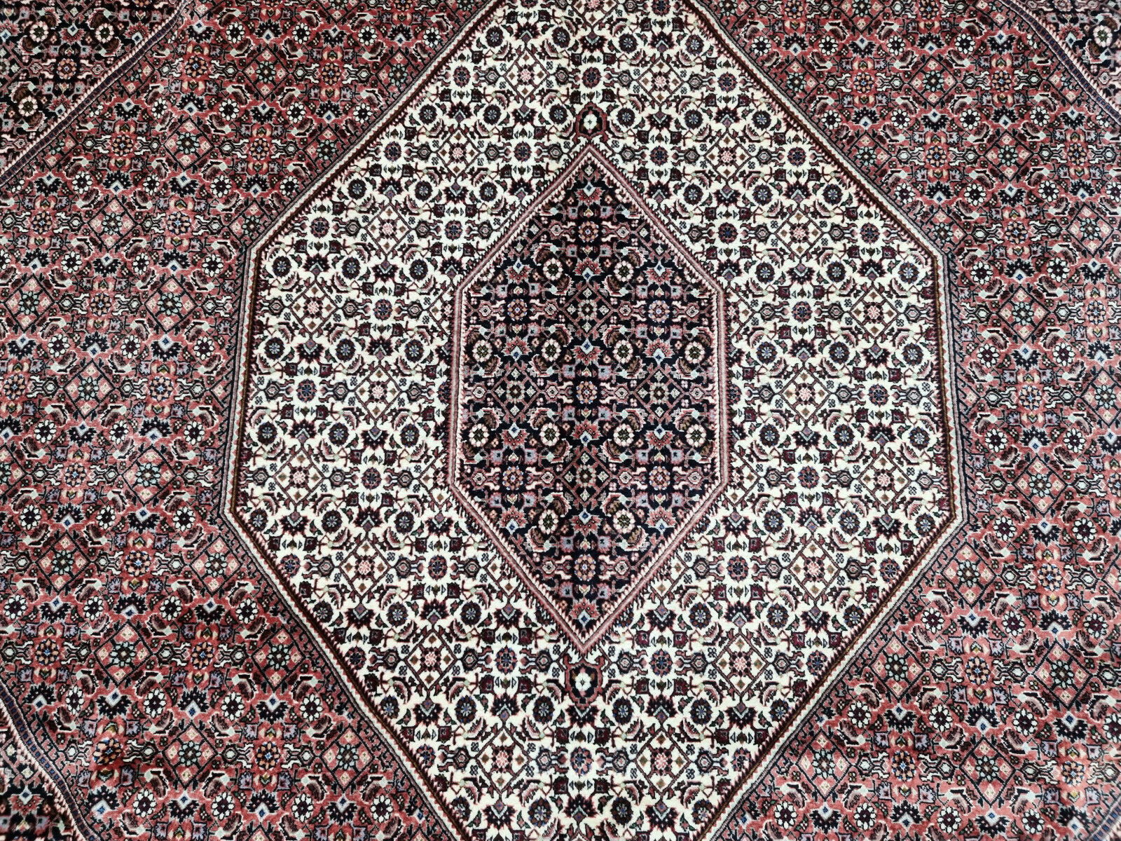 Close-up of deep red tones on Handmade Vintage Persian Bidjar Rug - Detailed view showcasing the rich red color palette of the rug.