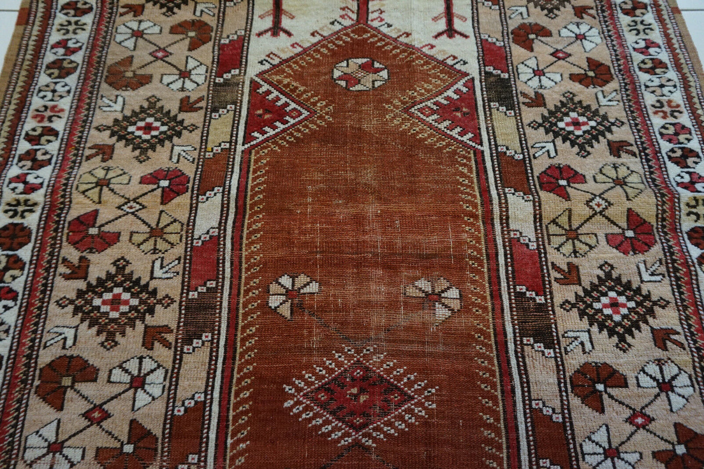 Close-up of the warm, earthy primary color on the Handmade Traditional Turkish Melas Rug
