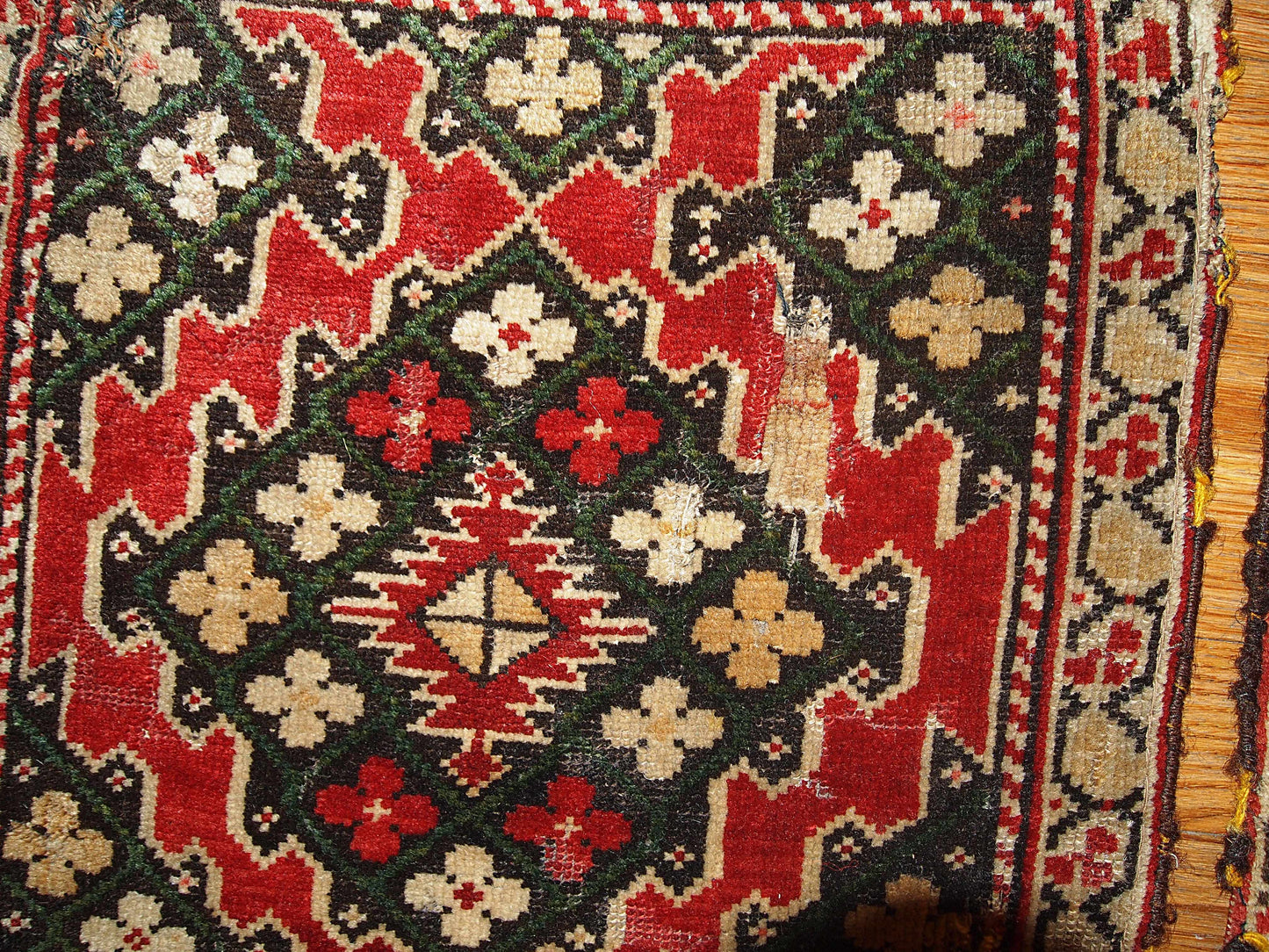 The pair of Armenian Karabaghs  in bright red color and beige borders. The darker shades of the rugs are not completely matchable: on one of them it has grass green color covering chocolate brown field and on another piece it is bright blue.