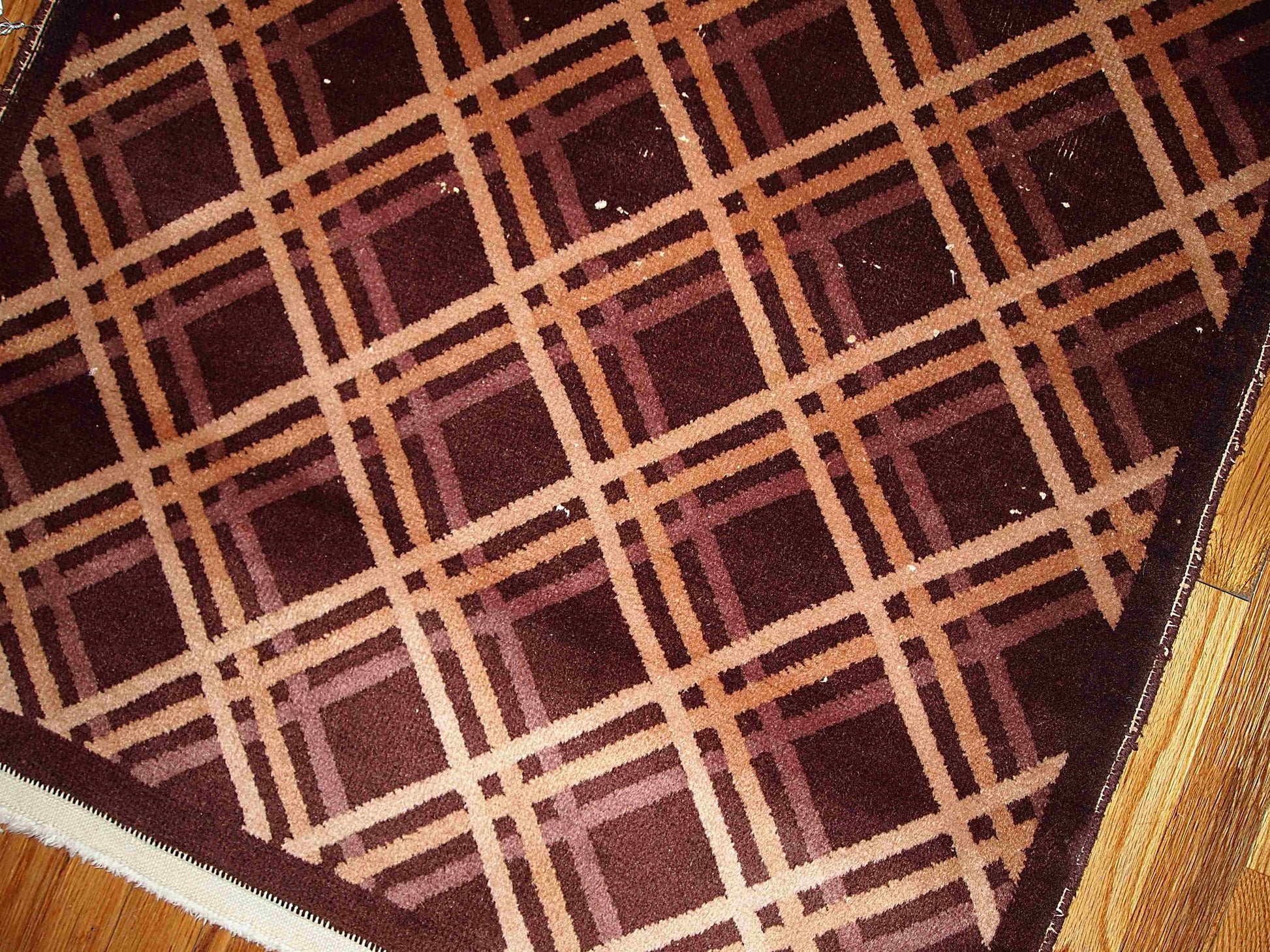 Antique hand made geometric Nichol Chinese rug in chocolate brown, burgundy, beige and cream colors are intertwined in the symmetric diamonds. 