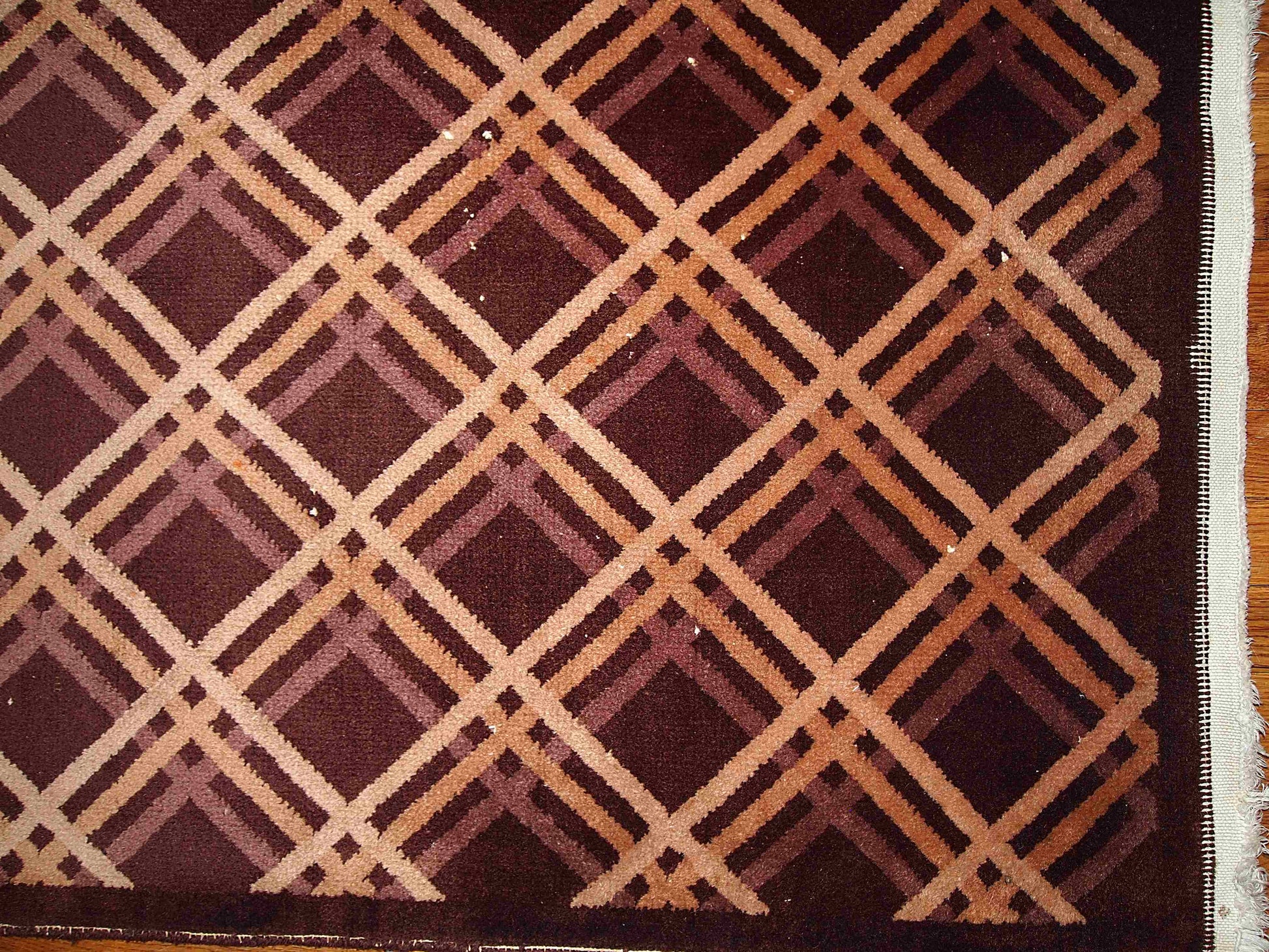Antique hand made geometric Nichol Chinese rug in chocolate brown, burgundy, beige and cream colors are intertwined in the symmetric diamonds. 