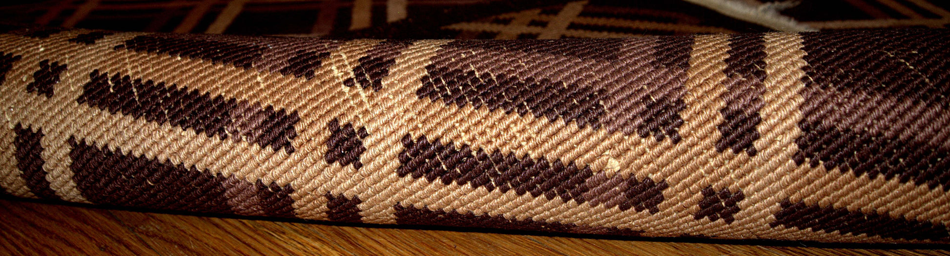 Antique hand made geometric Nichol Chinese rug in chocolate brown, burgundy, beige and cream colors are intertwined in the symmetric diamonds. 