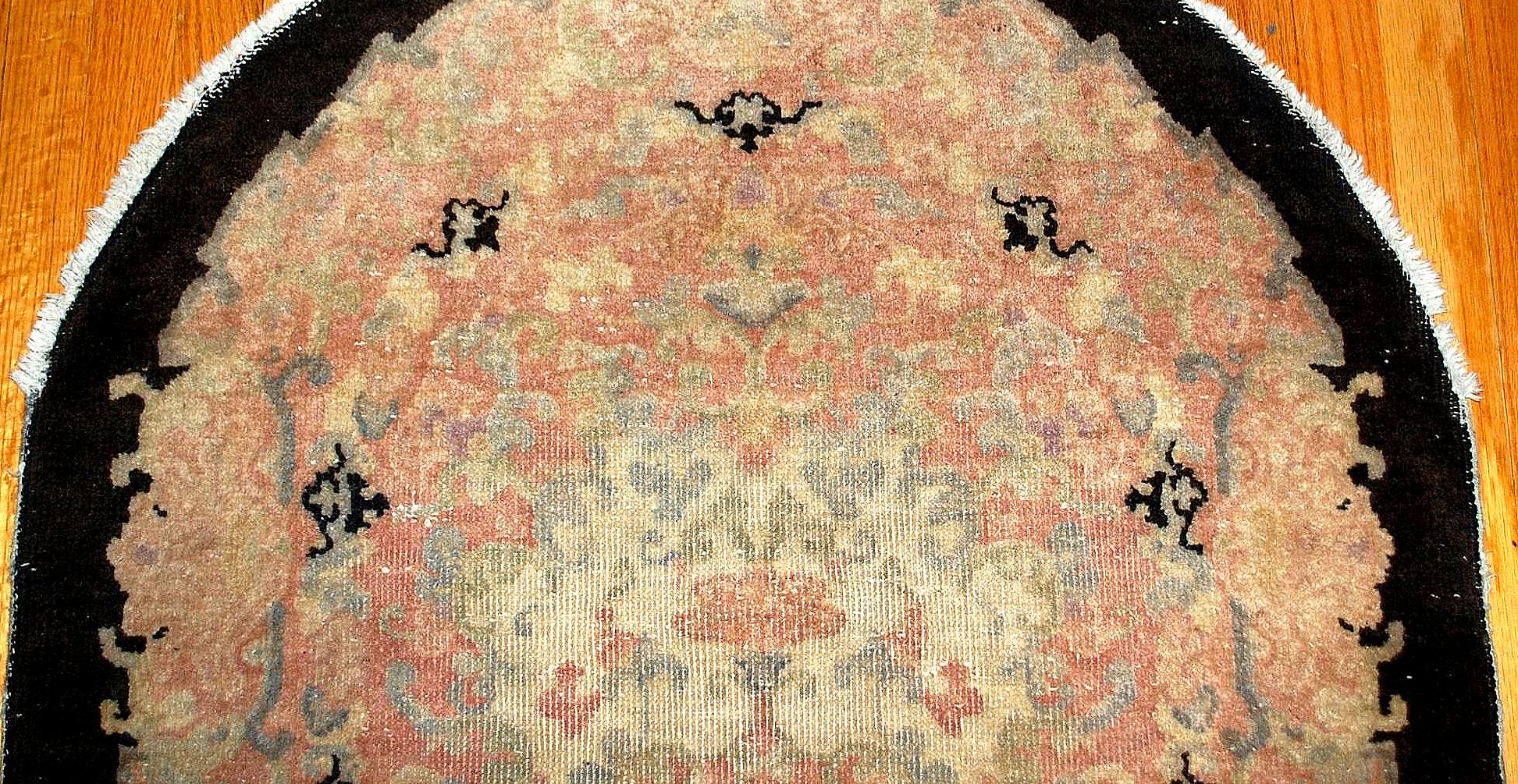 Beautiful oval Art Deco Chinese rug in pink, beige, sky blue and black shades. The rug is from the beginning of 20th century in original condition (low pile).